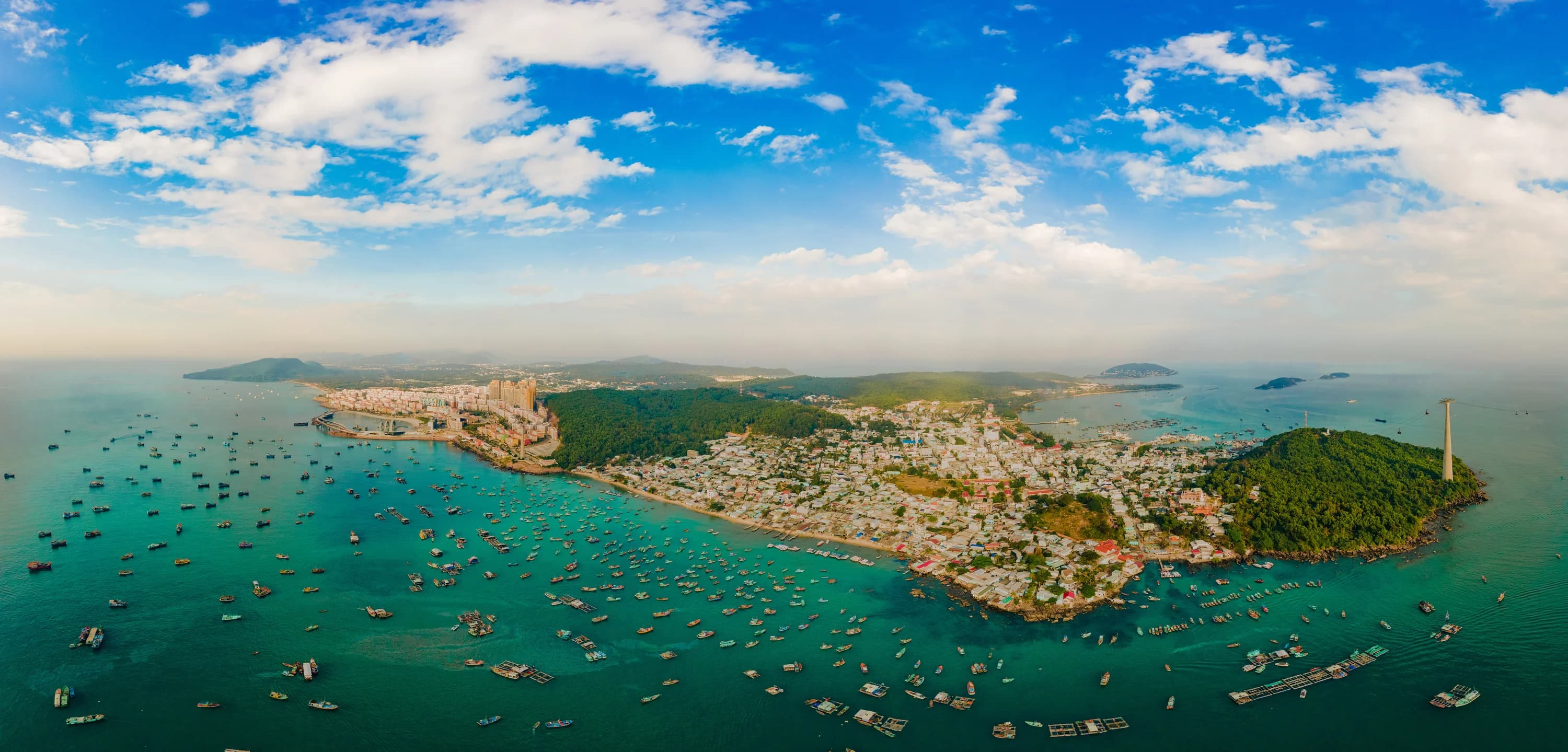 An Thoi harbour, boats and the southern town seen in a wide aerial panorama