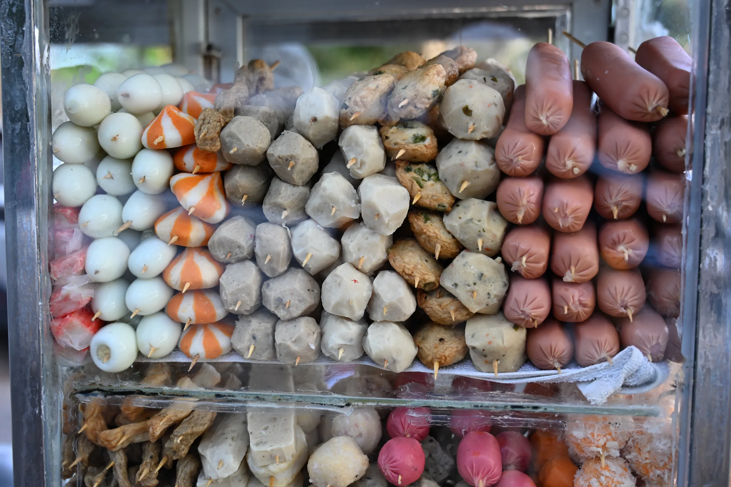 Skewers displayed at a beachside food stall in Ong Lang