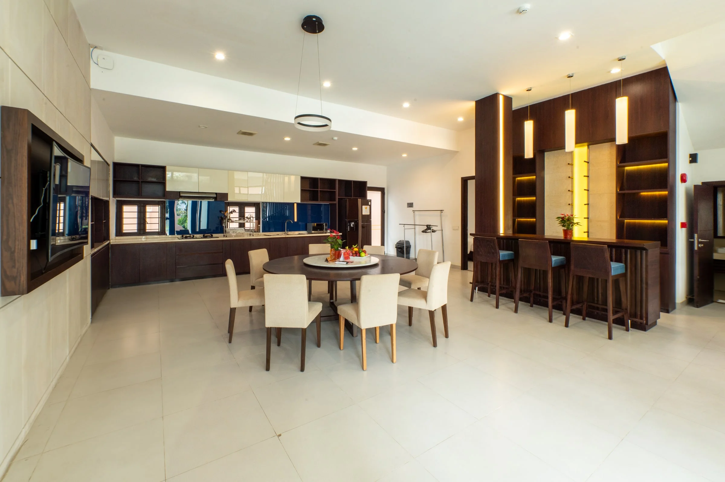 An open-plan kitchen with dining table and bar seating