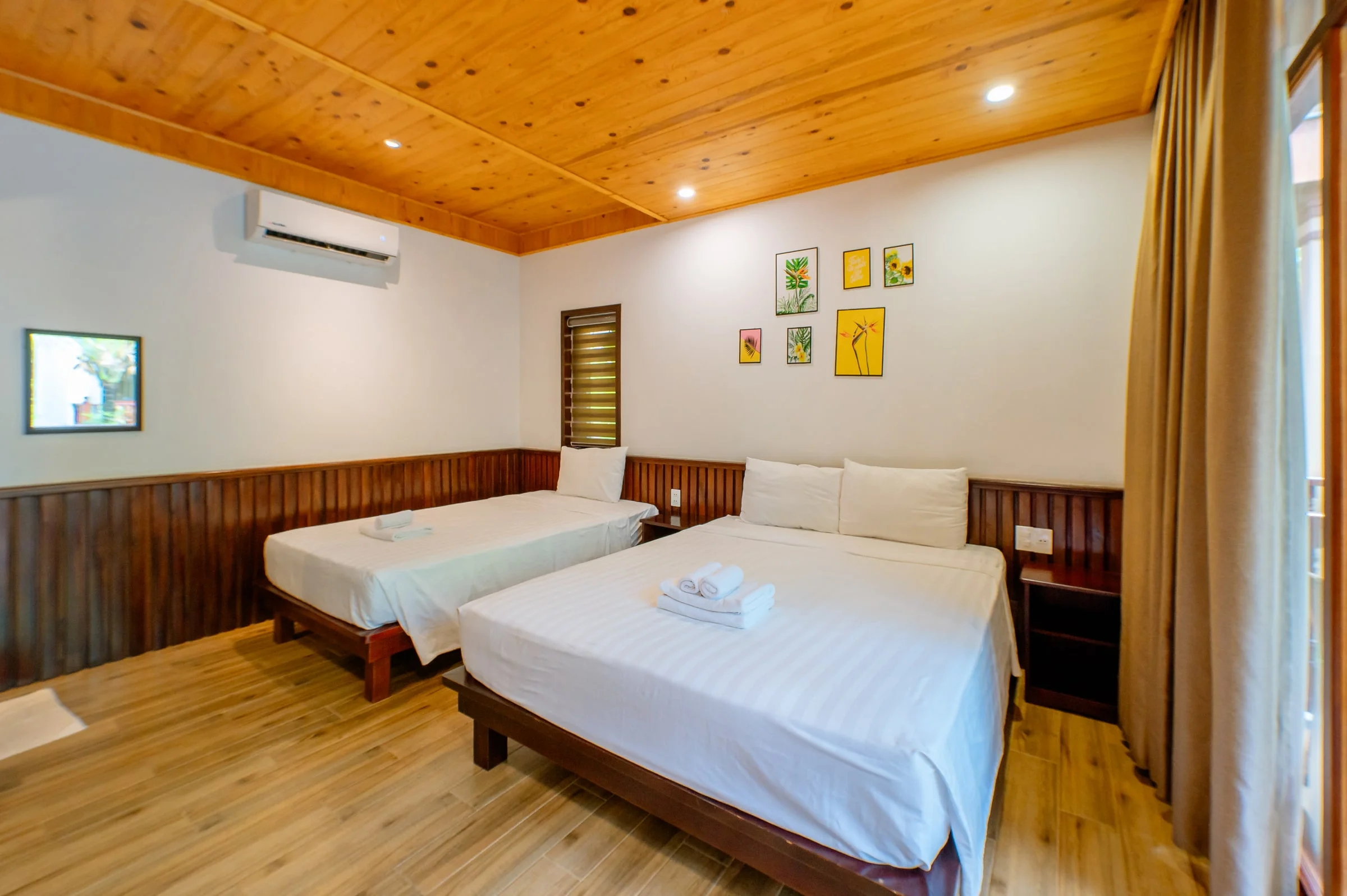 Two guest beds beneath a timber ceiling