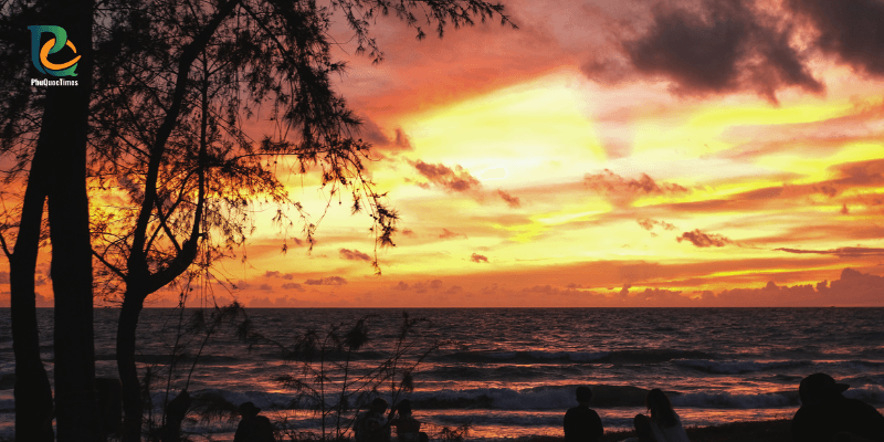 Golden sunset at Truong Beach Phu Quoc with silhouettes of people watching by the sea