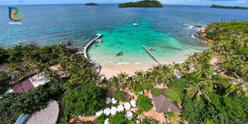 Aerial view of Hon May Rut Trong Island in Phu Quoc with turquoise water, white sand beach, wooden pier