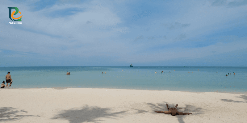 Tourists relaxing and swimming in the calm clear water of Khem Beach Phu Quoc on a sunny day
